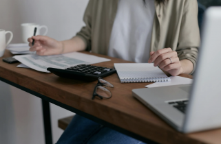 Woman Sitting at a Desk and Balancing the Books